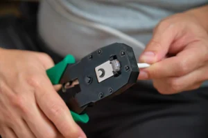 man-hands-attaching-net-cable-to-rj45-connector