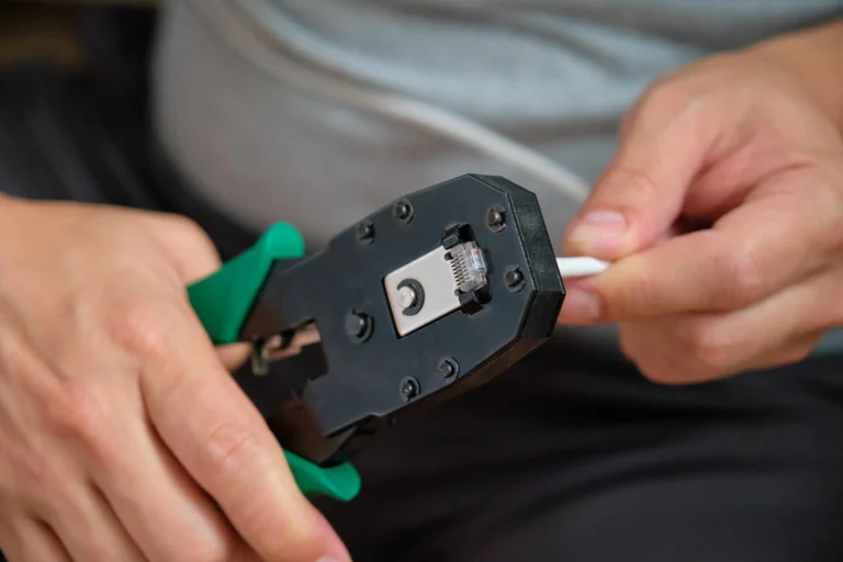 man-hands-attaching-net-cable-to-rj45-connector